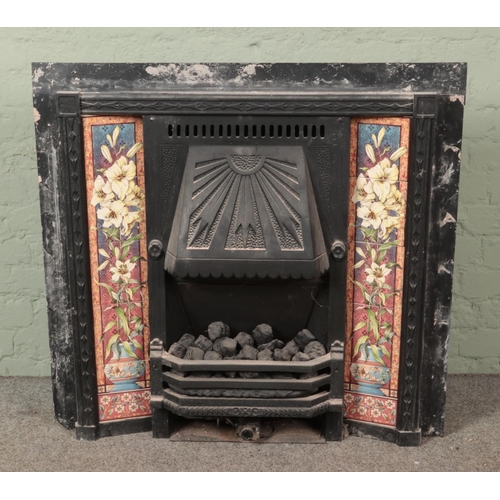 371 - A Victorian cast iron combination tiled fireplace. Hx92cm, Wx98cm.