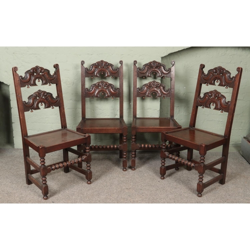 555 - A set of eight oak chairs. Having carved backs, jointed construction and bobbin turned stretchers. H... 