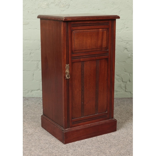 565 - An Edwardian mahogany bedside cabinet.