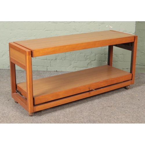 568 - A wood and Formica metamorphic sideboard/table.