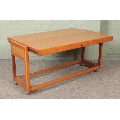 568 - A wood and Formica metamorphic sideboard/table.