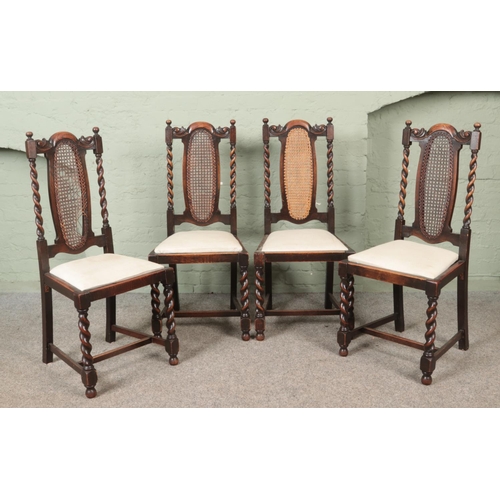 570 - A set of four oak chairs with barley twist supports and bergere back panels.