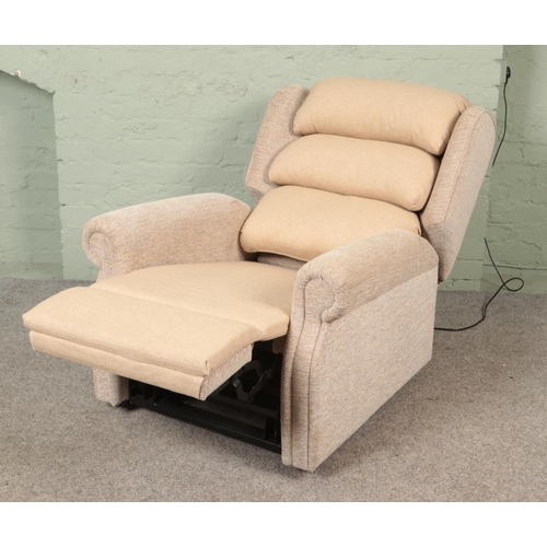 572 - A 2023 model Repose electric riser/recliner armchair, with remote, in cream upholstered fabric. Comp... 