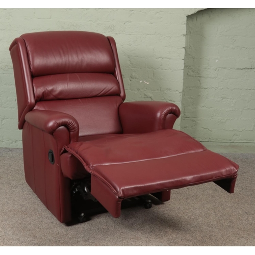 574 - A red leather reclining armchair.