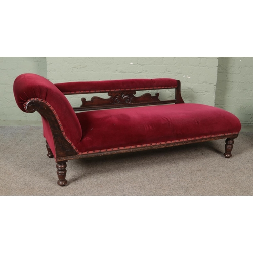 581 - A Victorian carved mahogany chaise lounge.