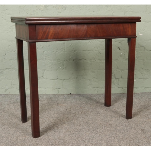 584 - A Georgian mahogany fold over tea table. Height: 72cm, Width: 77cm, Depth: 37cm.