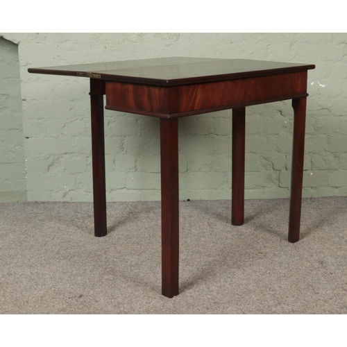 584 - A Georgian mahogany fold over tea table. Height: 72cm, Width: 77cm, Depth: 37cm.