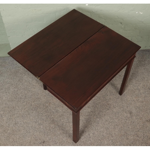 584 - A Georgian mahogany fold over tea table. Height: 72cm, Width: 77cm, Depth: 37cm.