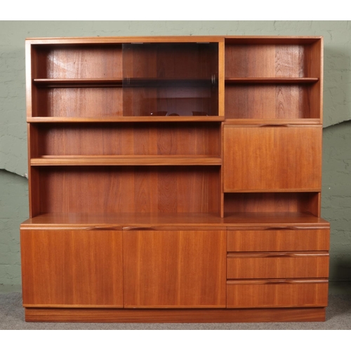 586 - A McIntosh two-tier teak wall unit, with glass sliding doors, shelving, drawers and cupboard drawers... 