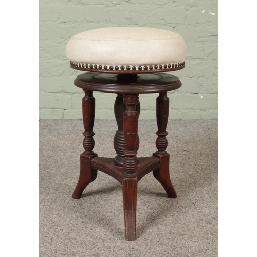 602 - An antique carved mahogany stool with adjustable seat.