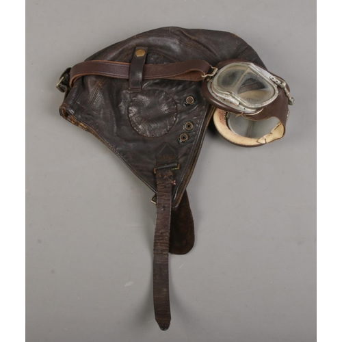 120 - A WWII period leather aviation helmet and goggles.