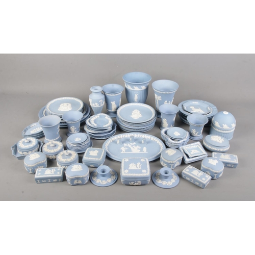 130 - A large collection of Wedgwood blue Jasperware. Includes 'Mother' plates, vases, trinket boxes, dish... 