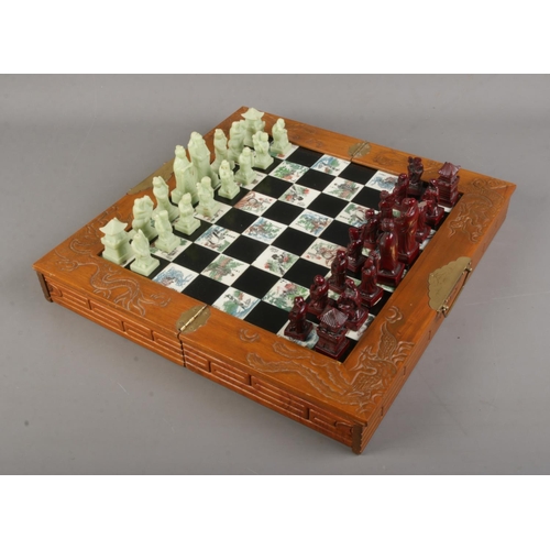 133 - An oriental style folding chess set.