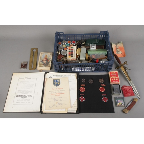 135 - A box of collectables. Includes coins, Dancing medals & certificates, postage weights, dagger with m... 