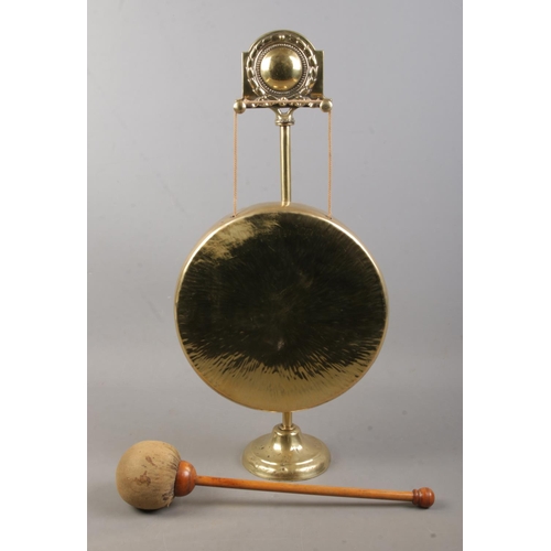 149 - A ornate brass gong with hammer. (54cm)