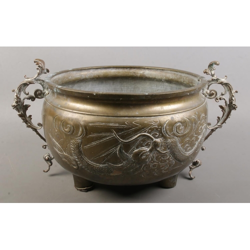 150 - An late 19th/early 20th century Oriental brass vessel with dragon decoration. Height 20cm. Diameter ... 