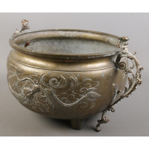 150 - An late 19th/early 20th century Oriental brass vessel with dragon decoration. Height 20cm. Diameter ... 