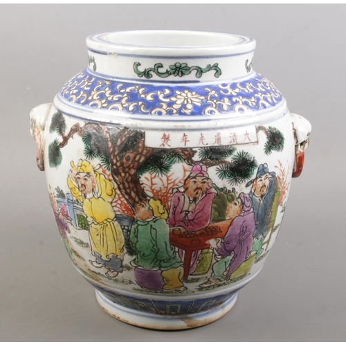 152 - A Chinese hand painted twin handle vessel. Decorated with figures and blue & white fish to the insid... 