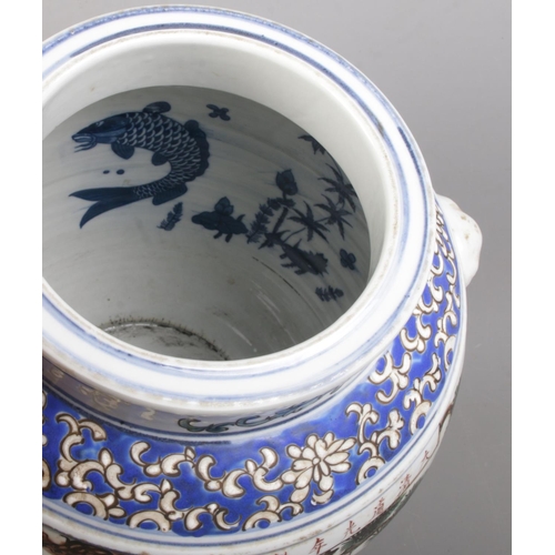 152 - A Chinese hand painted twin handle vessel. Decorated with figures and blue & white fish to the insid... 