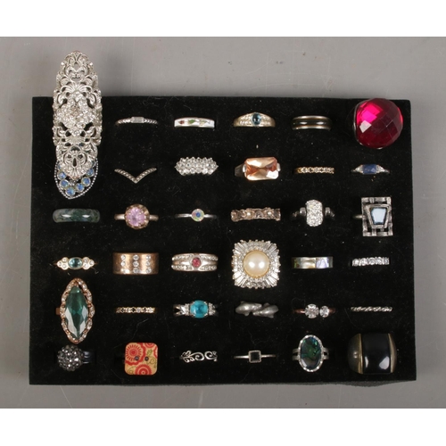 153 - A collection of costume jewellery dress rings. Includes paste set, enamel, wish bone etc.