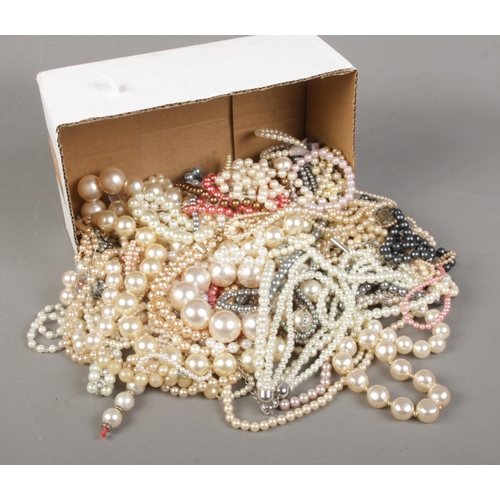 159 - A box of simulated pearl necklaces and bracelets.