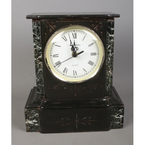 162 - A Wm. Widdop black slate and marble mantle clock featuring roman numeral dial.