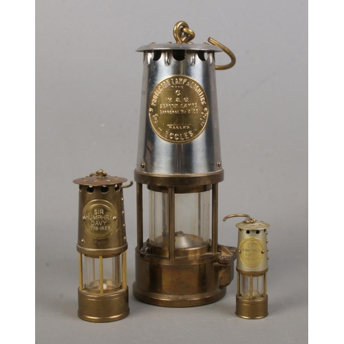 168 - An Eccles Type 6 miners lamp along with two miniature mining lamps inscribed Sir Humphry Davy, 1778-... 