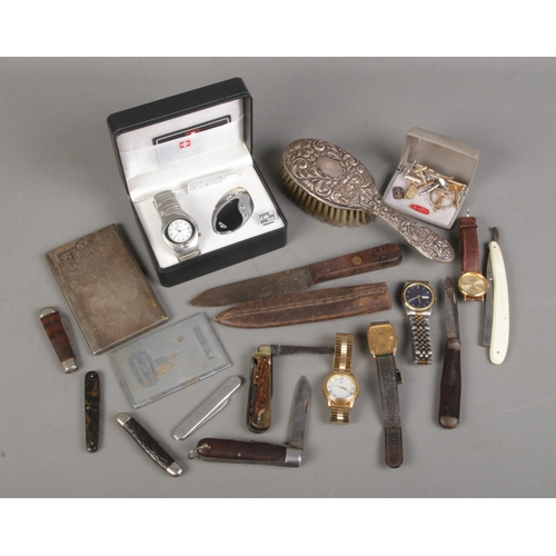 177 - A box of collectables. Includes  wristwatches, silver hand brush, pocket knives, silver plate cigare... 