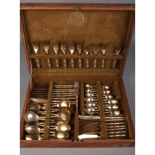 19 - A wooden cased six place Thai gilt metal canteen of cutlery, with the handles formed as bamboo canes... 