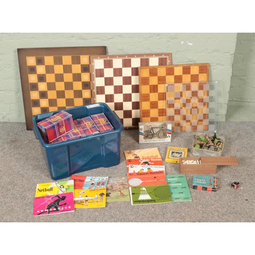 188 - A box of assorted toys and games to include large quantity of unopened playing cards, several chess ... 