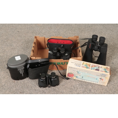 200 - A box of assorted items. Includes Celestron and Mark Scheffel binoculars, Ronco portable sewing mach... 