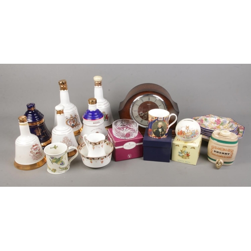 202 - A mixed quantity of collectable including bells whisky decanters (empty) various ceramics including ... 