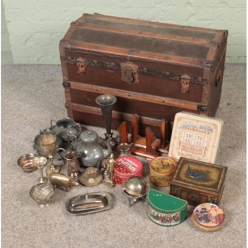 203 - A vintage dome top trunk filled with various metalwares including silver plate, brass and tins