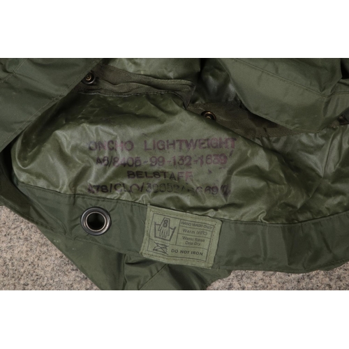 212 - A military canvas kit bag. Includes lightweight poncho marked 'Belstaff', enamel mug etc.