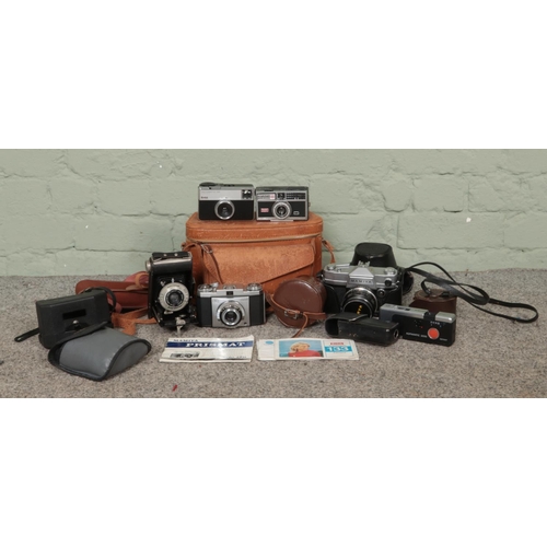 228 - A quantity of cameras and camera equipment to include Kodak Brownie, Instamatic 300, Mamiya Prismat ... 