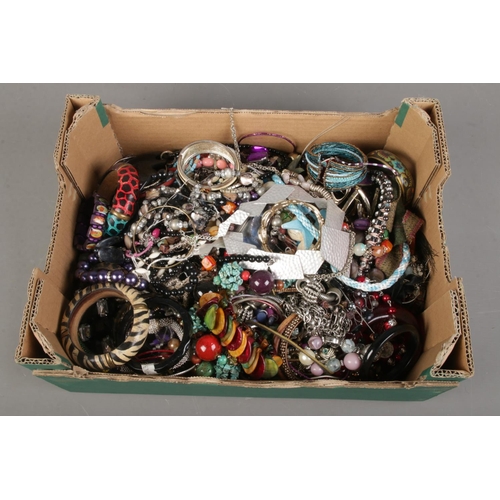 229 - A large box of costume jewellery. Includes bangles and necklaces.