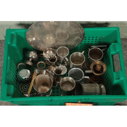 265 - A box of metalwares. Includes silver plate trays, teapots, tankards, hipflasks, etc.