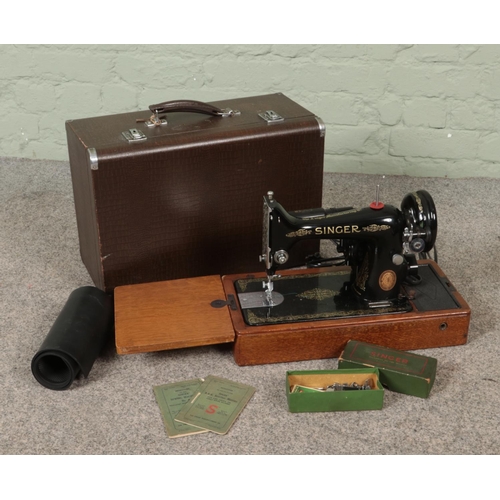 271 - A cased Singer electric sewing machine.