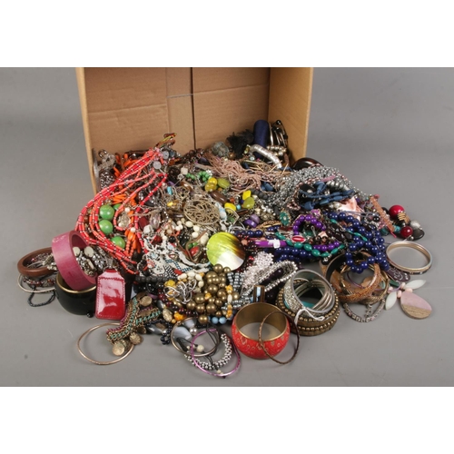 272 - A large box of costume jewellery. Includes bangles and necklaces.