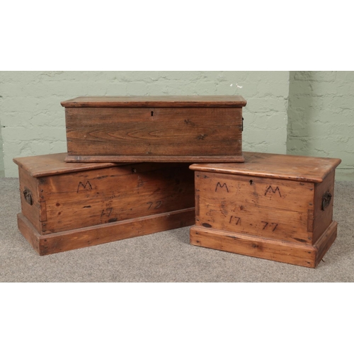 298 - Three hinged top pine chests, two with MM 1777 branded to the front.