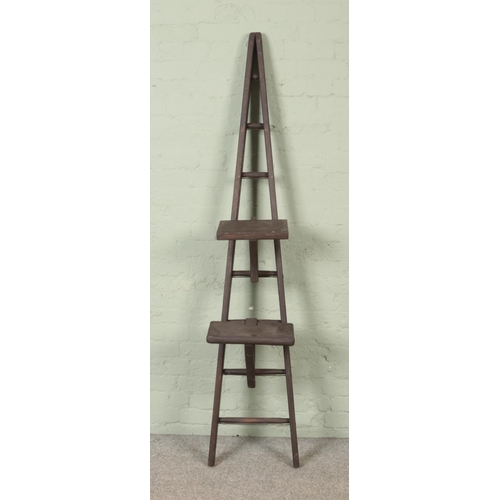 300 - A painted seven rung wooden A-Frame ladder, possibly for fruit picking, with two platform steps. Hei... 