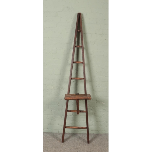 303 - A seven rung wooden A-Frame ladder, possibly for fruit picking, with a platform step. Height: 204cm.