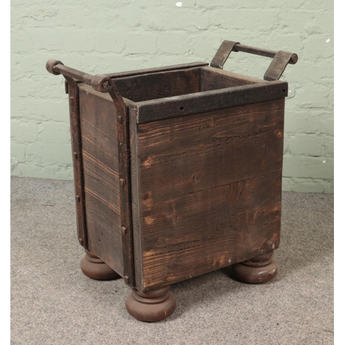 311 - A panelled log basket featuring metal surround and handles on bun feet.

Hx62cm
Wx58cm
Dx38cm