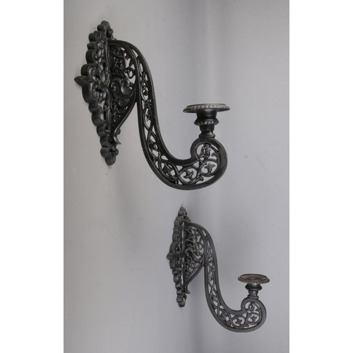 314 - A pair of cast iron black wall mounted sconces 

Hx50cm approx