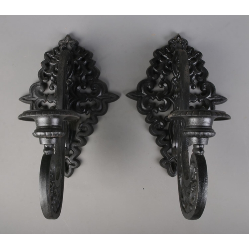 314 - A pair of cast iron black wall mounted sconces 

Hx50cm approx