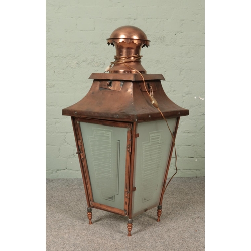 325 - A copper lantern with etched glass panels. Height 90cm.