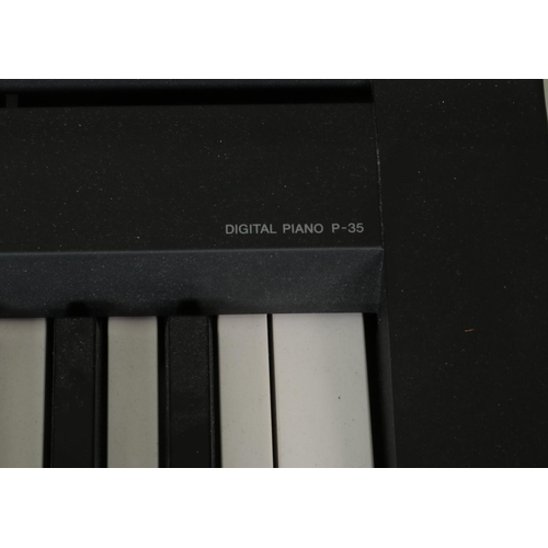 330 - A Yamaha P-35 Digital Piano, on stand with stool, with additional LP5A foot pedal. Complete with ins... 