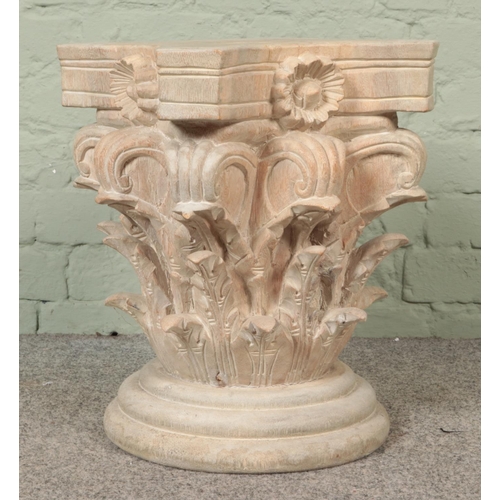 351 - An extensively carved wooden pedestal plinth, with turned stepped base. Height: 46cm, Width: 44cm.