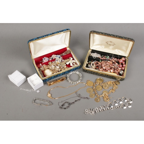 65 - Two jewellery boxes with contents of costume jewellery. Includes bracelets, beads, silver pendant an... 