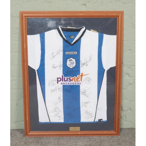 384 - A framed Diadora Sheffield Wednesday shirt from the 2007/2008 season, bearing seventeen players sign... 